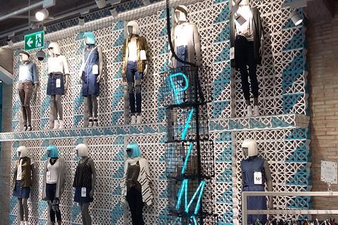 A the two-tiered bevvy of mannequins set against a white wire grid just inside the entrance sets the fashion scene for those coming into the shop